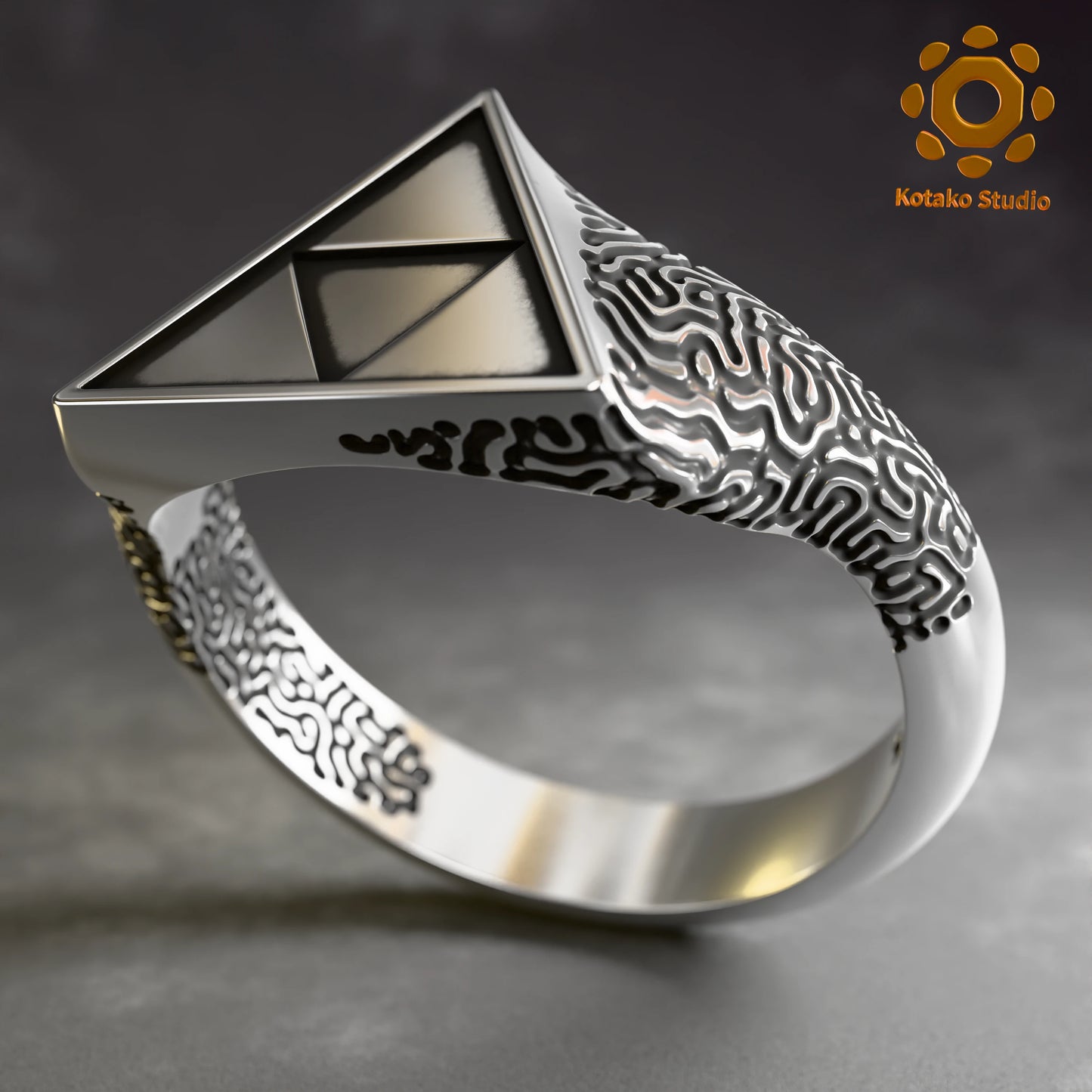 Sterling silver Zelda Triforce ring with an Ancient Shrine pattern inspired by Breath of the Wild. Angled front view.