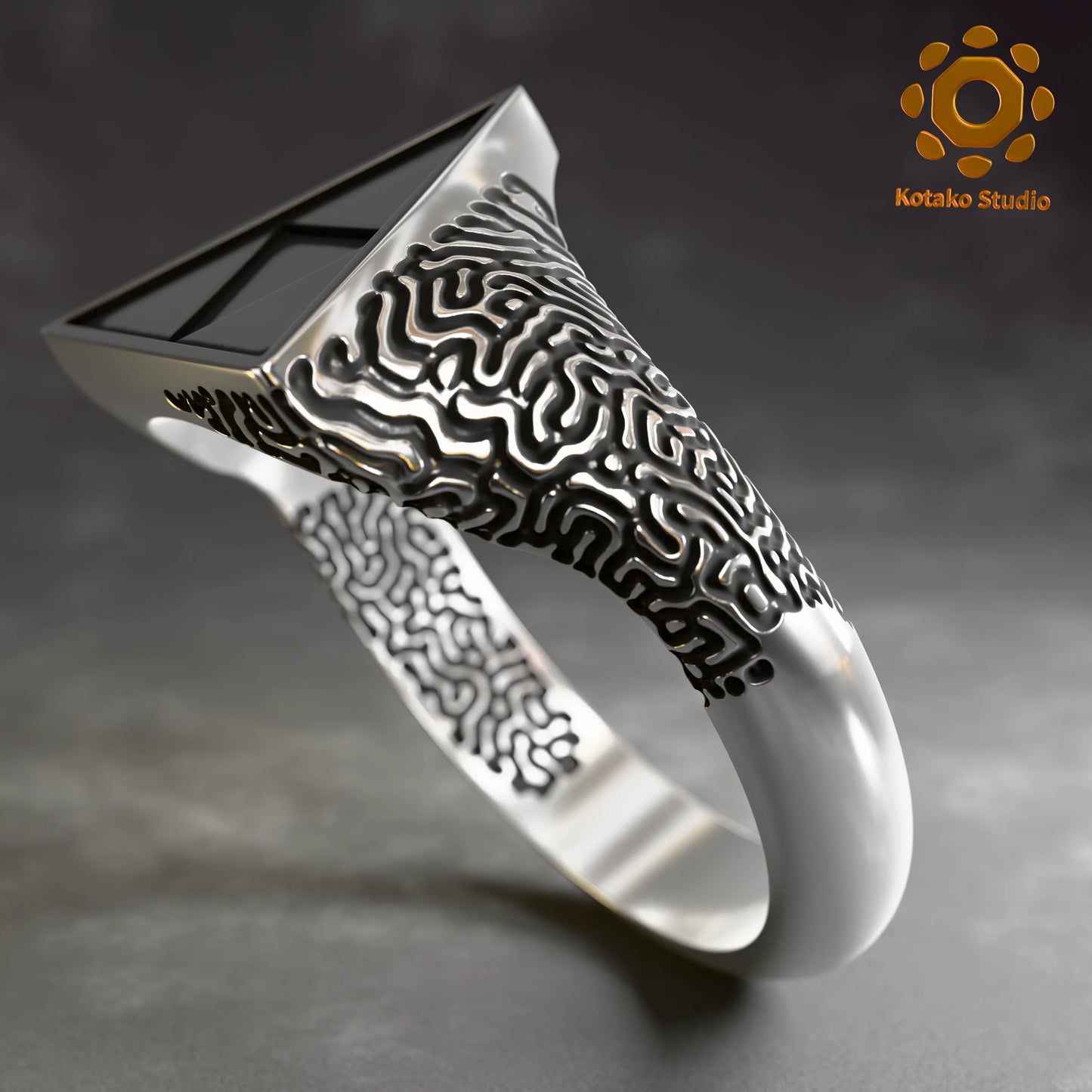 Sterling silver Zelda Triforce ring with an Ancient Shrine pattern inspired by Breath of the Wild. Angled side view.