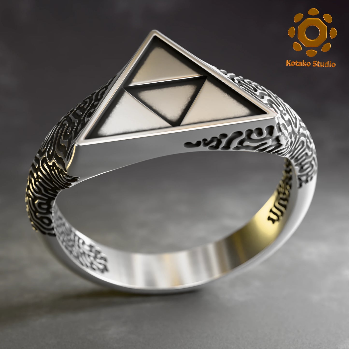 Sterling silver Zelda Triforce ring with an Ancient Shrine pattern inspired by Breath of the Wild. Angled front view.